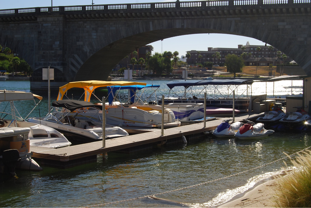 This public dock has various boats and jet skis docked. 